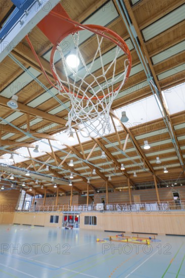 A basketball hoop in a sports hall with wooden structure and neon lighting, Schlehengäu Sporthalle Gechingen, Calw district, Germany
