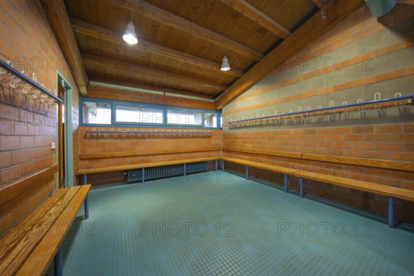 Large brick changing room with benches and coat hooks, Schlehengäu Sporthalle Gechingen, Calw district, Germany