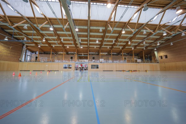 Empty sports hall with floor lines, wooden structure and several basketball hoops, Schlehengäu Sporthalle Gechingen, Calw district, Germany
