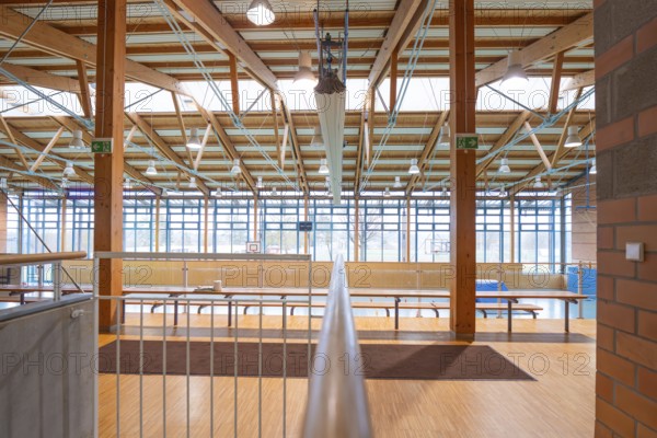 Spacious interior of a sports hall with wooden beams and large windows that let in lots of light, Schlehengäu sports hall Gechingen, Calw district, Germany