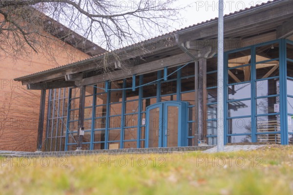 Modern architecture with large glass windows and wooden elements next to a wooded area, Schlehengäu sports hall Gechingen, Calw district, Germany