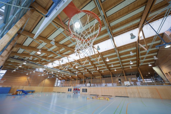 Basketball hoop in a large sports hall with wooden structure and floor markings, Schlehengäu Sporthalle Gechingen, Calw district, Germany