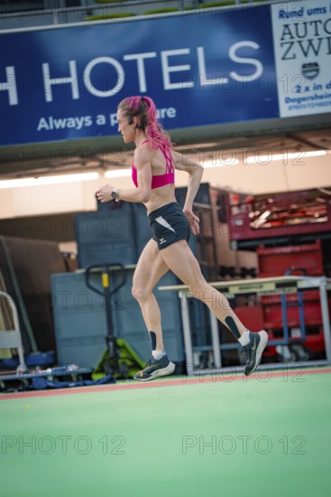 Female athlete dynamically running sideways through the interior of a hall, middle distance runner Katharina Jaiser, Sindelfingen Glass Palace, Germany