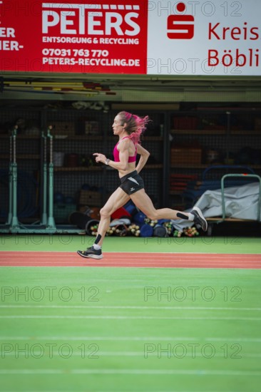 Female athlete sprints quickly through a hall, the movements are dynamic, middle distance runner Katharina Jaiser, Glaspalast Sindelfingen, Germany