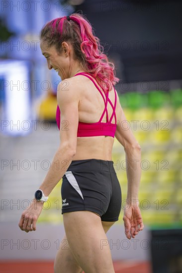 Back view of a woman with pink hair and sporty clothes, looks relaxed and satisfied, middle distance runner Katharina Jaiser, Sindelfingen Glass Palace, Germany
