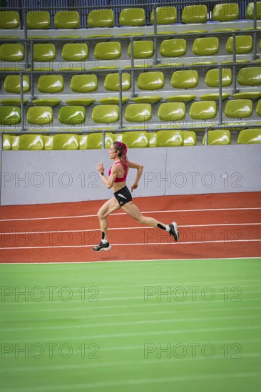 Female athlete running at high speed in an indoor sports hall, middle distance runner Katharina Jaiser, Sindelfingen Glass Palace, Germany
