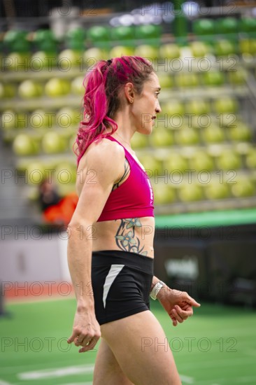 Side view of woman in sporty clothing, concentrated, with pink hair and tattoo, middle distance runner Katharina Jaiser, Sindelfingen Glass Palace, Germany