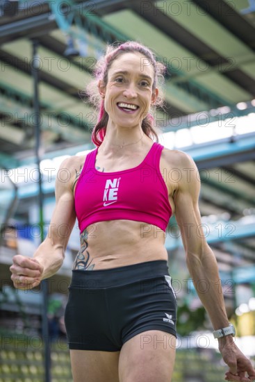 Sporty dressed woman with a smile indoors showing fitness and energy, middle distance runner Katharina Jaiser, Sindelfingen Glass Palace, Germany