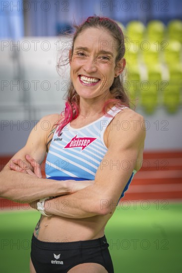 Self-confident sportswoman with pink hair in stadium, smiling friendly, middle distance runner Katharina Jaiser, Gechingen, Germany