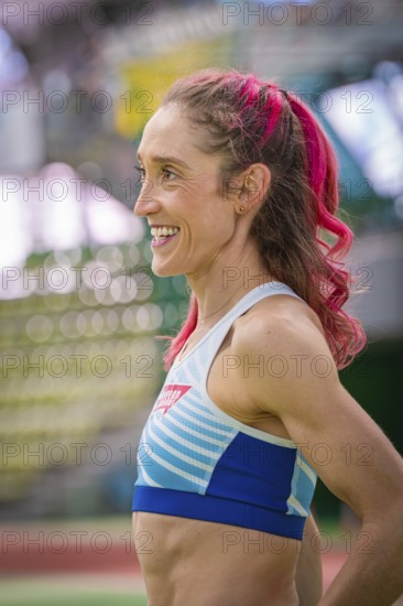 Happy sportswoman with pink hair in the stadium. Smiles and looks satisfied, middle distance runner Katharina Jaiser, Gechingen, Germany