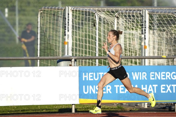 Woman running fast and dynamically on a sports track, middle distance runner Katharina Jaiser, Gechingen, Germany