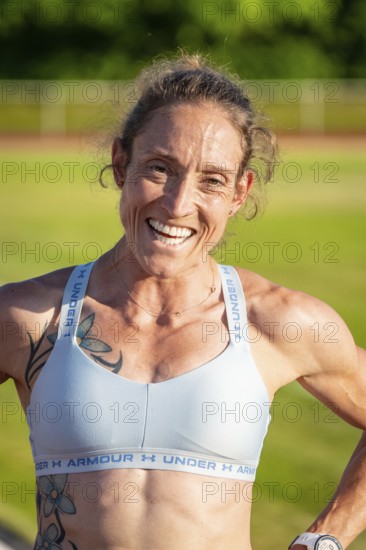 Close-up of laughing woman in sportswear with tattoos, middle distance runner Katharina Jaiser, Gechingen, Germany