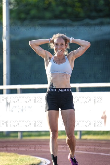 Woman smiling happily after a successful run on the track, middle distance runner Katharina Jaiser, Gechingen, Germany