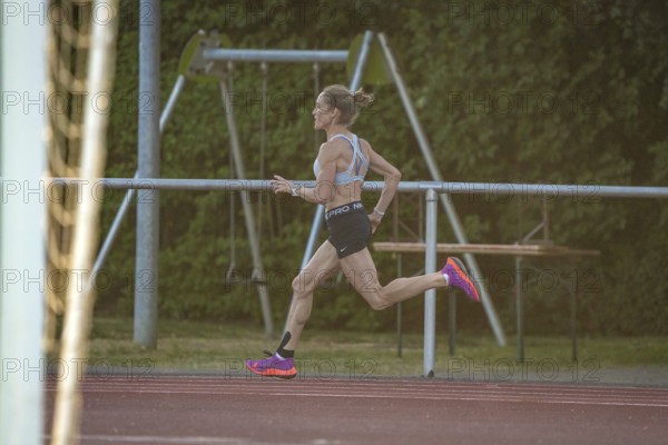 Woman runs intensively and concentrated along the track, middle distance runner Katharina Jaiser, Gechingen, Germany