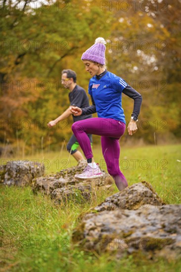 Training of men and woman over rocks in a colorful autumn environment, middle distance runner Katharina Jaiser, Gechingen, Germany