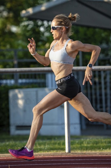 Athlete in full sprint on a running track, with energetic attitude in daylight, middle distance runner Katharina Jaiser, Gechingen, Germany