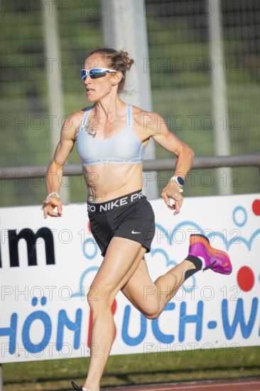 Focus on a sprinting athlete in sporty clothes in sunny weather, middle distance runner Katharina Jaiser, Gechingen, Germany