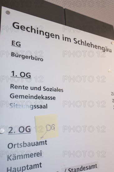 Guide in the building shows various offices and floors, bright room with lettering, Gechingen Town Hall, Calw district, Germany