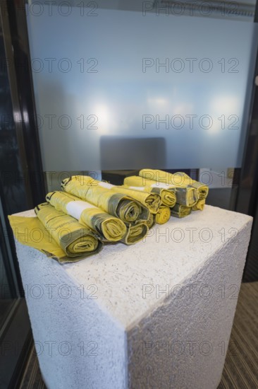 Yellow rolled up fabrics on a concrete base in a simple setting, Gechingen Town Hall, Calw District, Germany