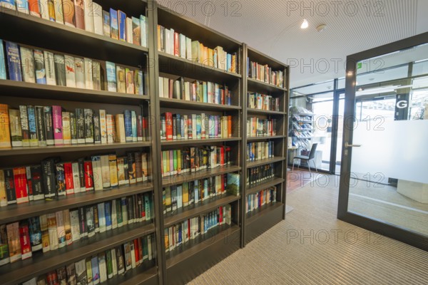 Modern library with bookshelves and glass walls, cozy atmosphere, Gechingen Town Hall, Calw district, Germany