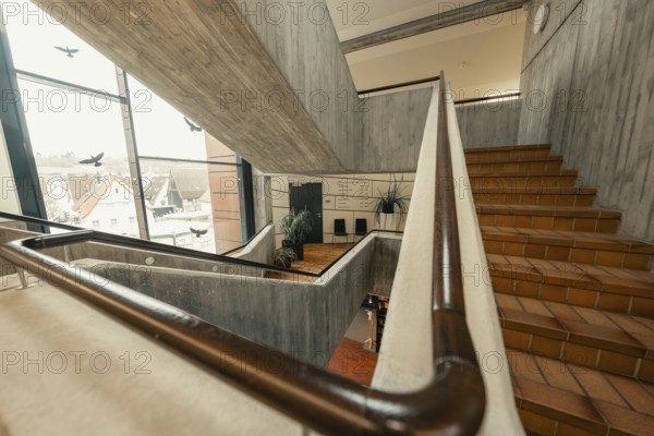 Modern staircase with concrete walls and windows, open architecture with city view, Gechingen Town Hall, Calw district, Germany