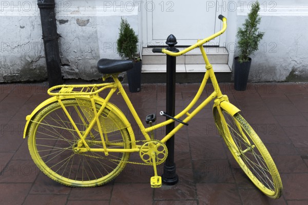Bicycle painted yellow, Krakow, Poland