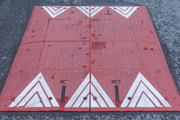 Red and white bump in a residential street in Lan´cut, formerly Landshut, Poland