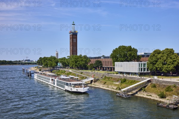 Rhine river, Rheinhallen exhibition halls, brick architecture, exhibition tower, general architecture, bridge, waterfront, river cruise ship Viking Einar, Viking Cruises, pier, Duckdalben, gangway, wharf, wharf, trees, bird's-eye view, blue sky, cirrus clouds, Kennedy shore, Cologne, district-free city, North Rhine-Westphalia, Germany