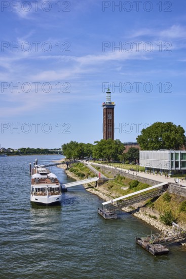 Rhine river, Rheinhallen exhibition halls, brick architecture, exhibition tower, general architecture, high-rise buildings, waterfront, river cruise ship Viking Einar, Viking Cruises, pier, Duckdalben, gangway, wharf, wharf, trees, bird's-eye view, blue sky, cirrus clouds, Kennedy shore, Cologne, district-free city, North Rhine-Westphalia, Germany