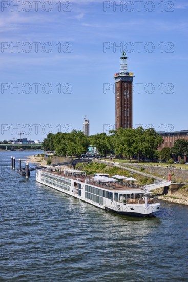 Rhine river, Rheinhallen exhibition halls, brick architecture, exhibition tower, general architecture, bridge, waterfront, river cruise ship Viking Einar, Viking Cruises, pier, Duckdalben, gangway, wharf, wharf, trees, bird's-eye view, blue sky, cirrus clouds, Kennedy shore, Cologne, district-free city, North Rhine-Westphalia, Germany