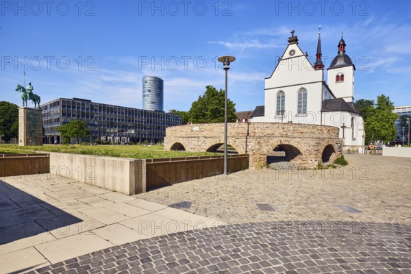 Historic railway hub, Alt St. Heribert church, general architecture, commercial building, high-rise building, equestrian statue, lantern, cobblestone sidewalk and natural stone slabs, lawn, blue sky, cirrus clouds, Urbanstraße, Kennedy-Ufer, Cologne, district-free city, North Rhine-Westphalia, Germany