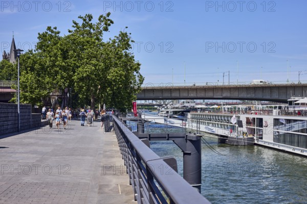 Rhine river, waterfront, metal railing, lantern, ship, gangway, bridge, Deutz bridge, pedestrian as accessories, trees, blue sky, cloudless, Leystapelwerft, Cologne, district-free city, North Rhine-Westphalia, Germany