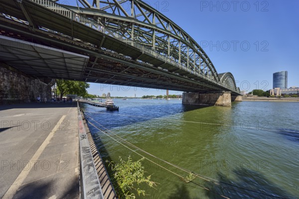 Rhine river, Hohenzollern Bridge pedestrian and railway bridge, steel arches, MaxCologne high-rise building, general architecture, waterfront, metal railings, blue sky, cloudless, Trankgassenwerft, Cologne, district-free city, North Rhine-Westphalia, Germany