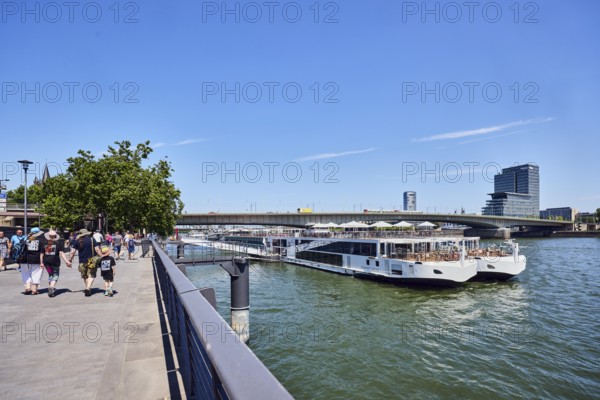 Rhine river, Viking Hlin river cruise ship, Viking Cruises, car bridge and footbridge, waterfront, metal railings, skyscrapers, pedestrians as accessories, trees, blue sky, cirrus clouds, Leystapelwerft, Cologne, district-free city, North Rhine-Westphalia, Germany