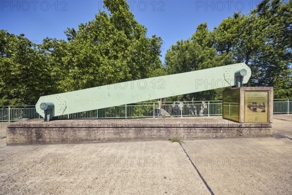 Hindenburg Bridge monument, historic chain link of a suspension bridge, metal railing, concrete slab walkway, trees, blue sky, cloudless, Deutz bridge, Cologne, district-free city, North Rhine-Westphalia, Germany