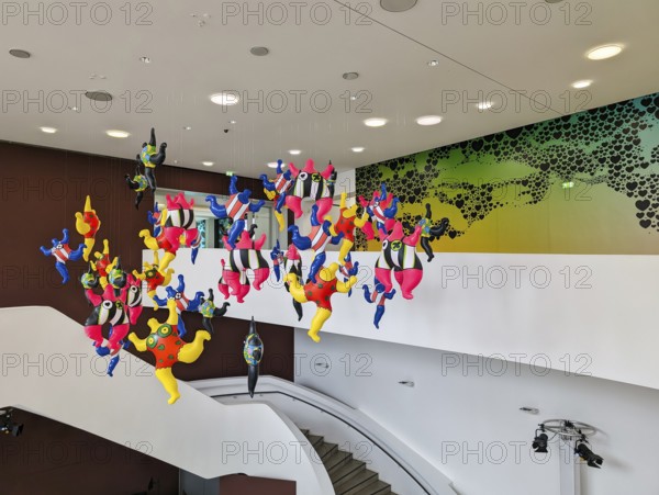 Colorful sculptures, Nanas, artist Niki de Saint Phalle, colorful figures, woman hanging in the stairwell, feminist art, Love you for Infinity exhibition at the Sprengel Museum, Hanover, Germany
