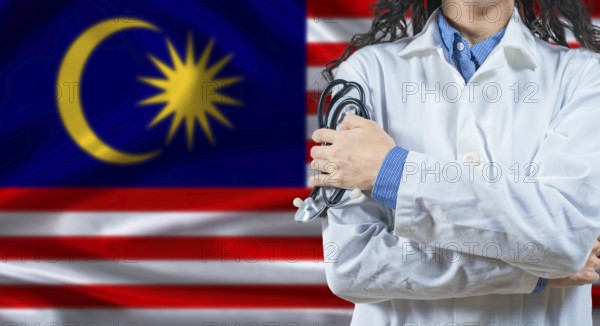 Malaysian healthcare professional with Malaysia flag background. Professional doctor holding stethoscope on Malaysia flag background