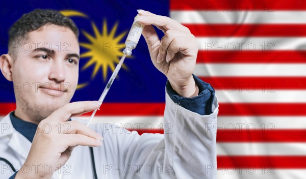 Malaysian doctor holding syringe on Malaysia flag background. Medical professional holding syringe with Malaysian flag in the background