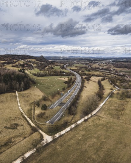 The A81 motorway passes through the 782 meter long Hohentwiel Tunnel just in front of the Swiss border, the Hohenkrähen Hegau volcano on the left, aerial view, Konstanz district, Baden-Württemberg, Germany