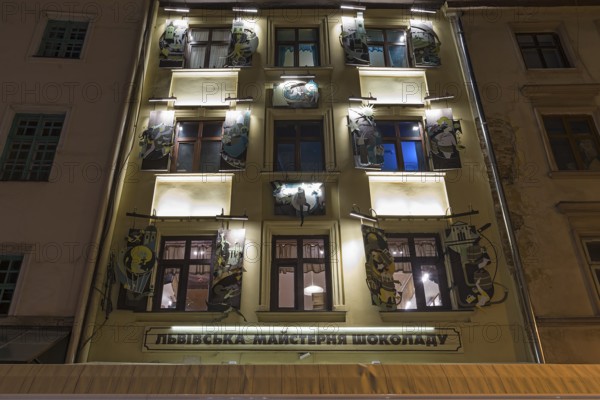 Apartment house with painted shutters in evening lighting, Lviv, Ukraine