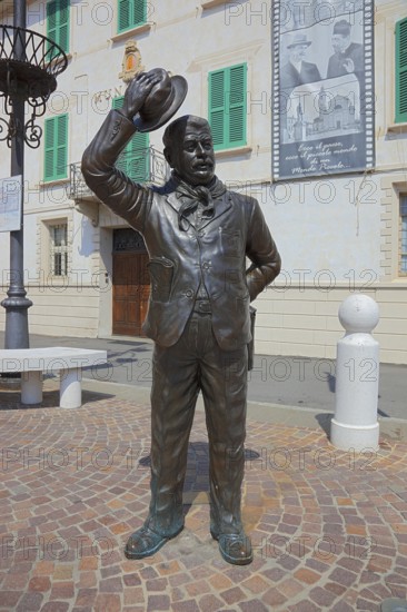 Italy, village of Brescello, the town hall, known from Don Camillo and Peppone, with a bronze figure of Peppone, Mayor Giuseppe Bottazzi portrayed by actor Gino Cervi