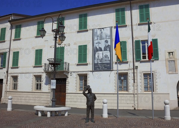 Italy, village of Brescello, the town hall, known from Don Camillo and Peppone, with a bronze figure of Peppone, Mayor Giuseppe Bottazzi portrayed by actor Gino Cervi