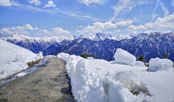 Alpine mountain landscape, hiking trail on the Fellhorn surrounded by snow with panoramic views of snow-capped mountains in spring, Allgäu, Alps, Bavaria, Germany