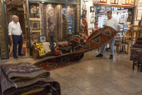 Istanbul, Turkey. June 23rd 2025. Antique carpet and rug traders doing business in the Grand Bazaar, Istanbul, one of the largest and oldest covered markets in the world, Turkey