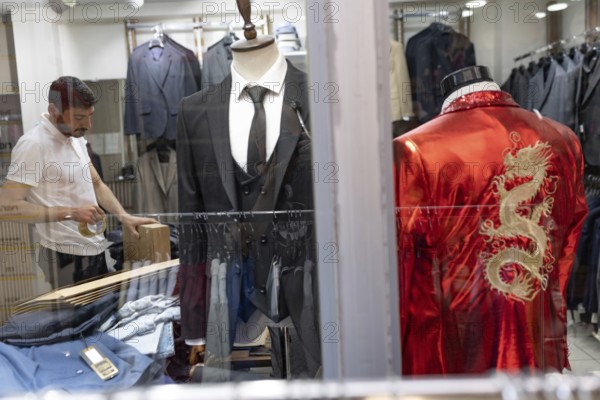 Istanbul, Turkey. June 23rd 2025. A Turkish tailors shop window with handmade suits on display near the Grand Bazaar, a busy shopping district in Fatih, Istanbul, Turkey
