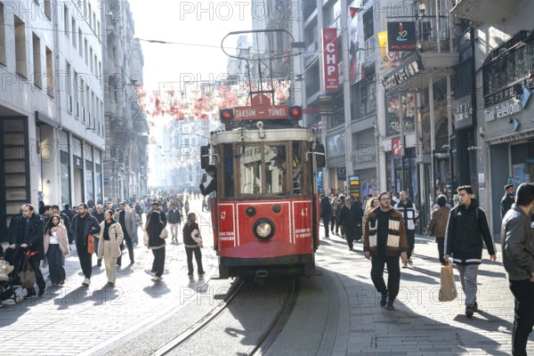 Istanbul, Turkey. December 2nd 2025. A traditional Turkish tram along street, busy with shoppers and pedestrians, Istanbul. Turkey