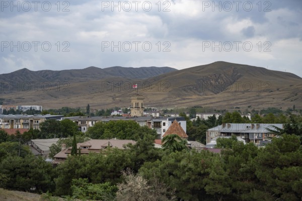 Gori, Georgia. September 9th 2025. Panoramic landscape view with the Georgian flag flying from the Stalin Museum building, Gori, Georgia
