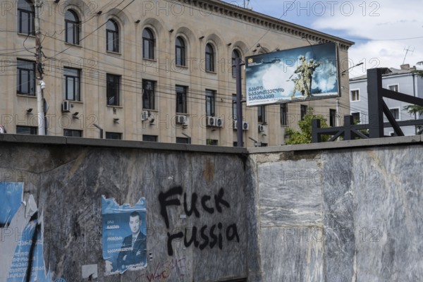 Gori, Georgia. September 10th 2025. Anti-Russia graffiti sprayed on a subway wall with a billboard requiting for the Georgian military in the center of Gori, birthplace of Joseph Stalin, Georgia