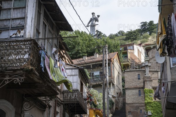 Tbilisi, Georgia. July 15th 2025. The Mother of Georgia statue seen from the narrow side streets and old houses of Tbilisi Old Town, Georgia