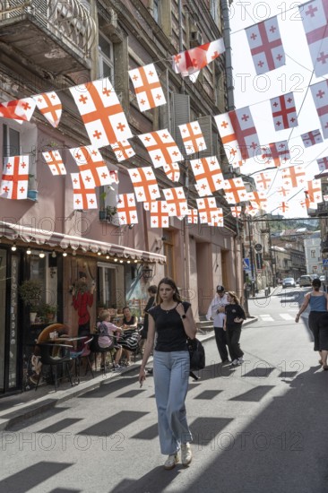 Tbilisi, Georgia. July 7th 2025. Georgian flags flutter over a side street in the Old Town in Tbilisi, Capital of Georgia